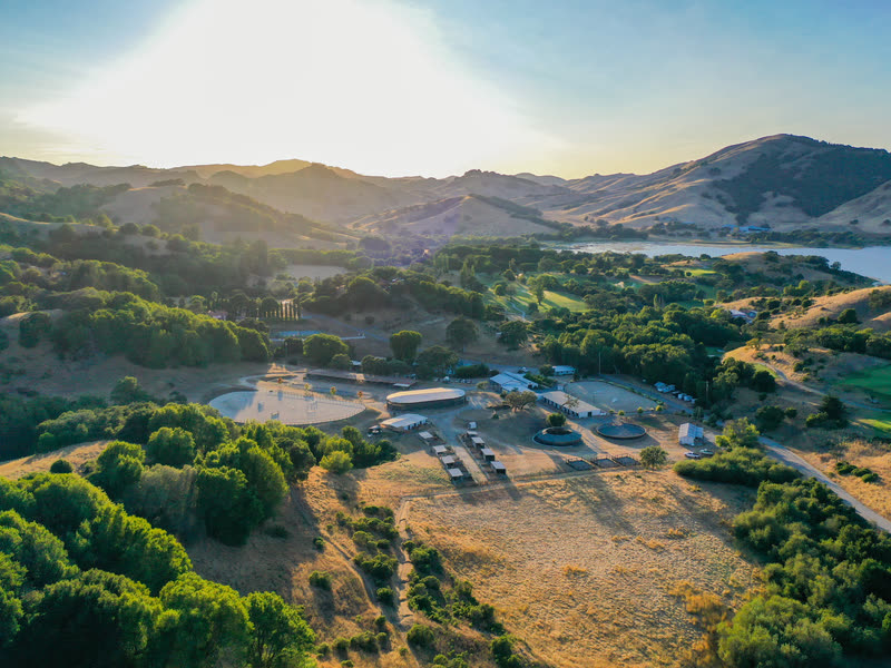 Hindsight Farms below the oak-covered Marin hills, with open space and Stafford Lake beyond.